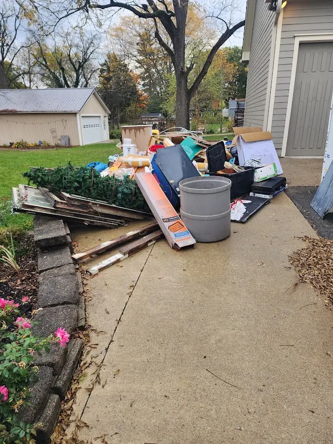 Dumpster being loaded with debris for 12 Yard Dumpster Rental in Franklin Town